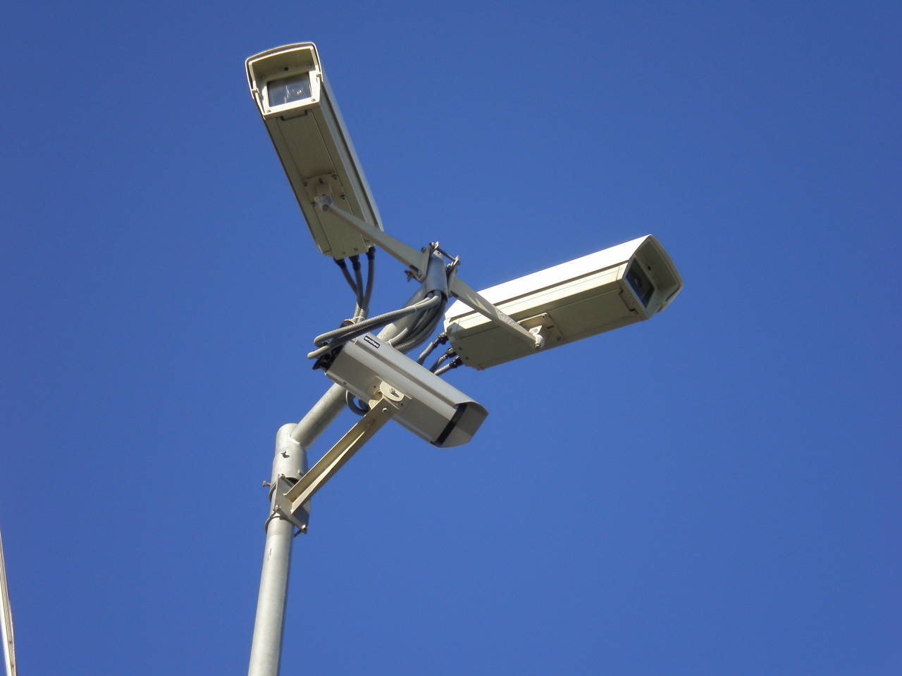 surveillance cameras with blue sky in the background