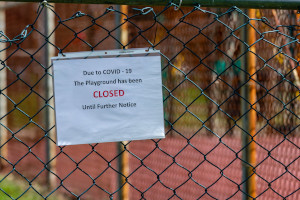 Closed playground with notice about COVID