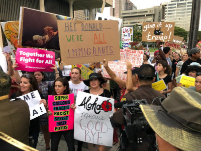 Protesters with sign 'We are all immigrants'
